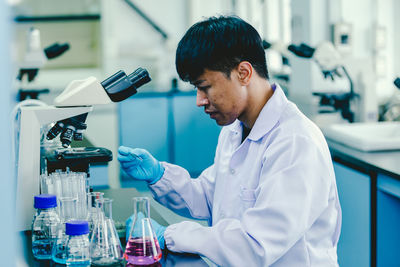 Portrait of young male scientist working in laboratory