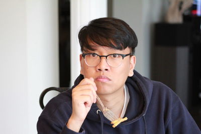 Portrait of man in eyeglasses at home