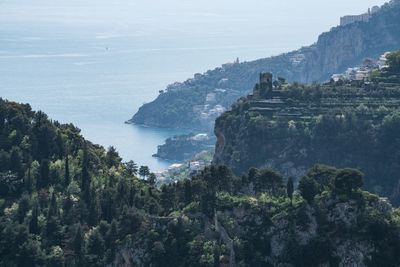 Scenic view of sea and mountains against sky