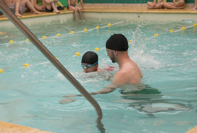 Teacher and student learning to swim