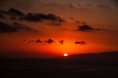 Scenic view of sea against romantic sky at sunset