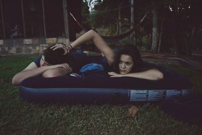 Young woman lying on grass