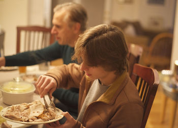 Thanksgiving dinner father and son seated at dinner table