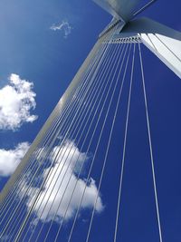 Low angle view of suspension bridge against sky