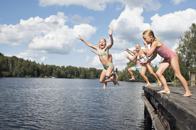 Boys and girls jumping into water