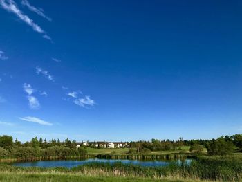 Scenic view of lake against blue sky