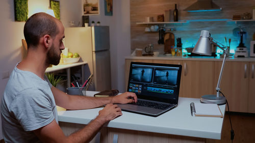 Side view of man working in office