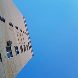 Low angle view of building against clear blue sky