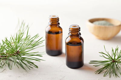 Pine essential oil in small glass bottles. soft focus.