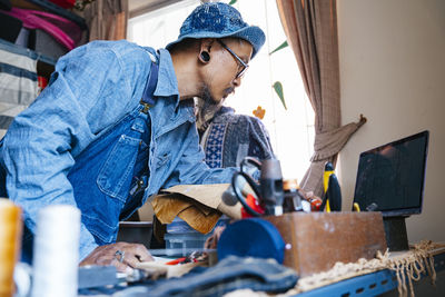 Side view of man working on table