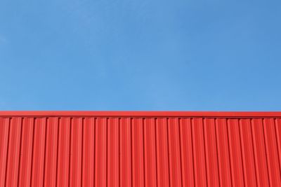 Red building structure against blue sky