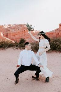 Couple kissing against clear sky