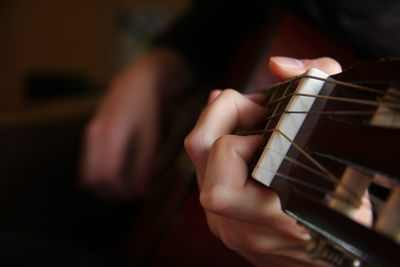 Midsection of person playing guitar