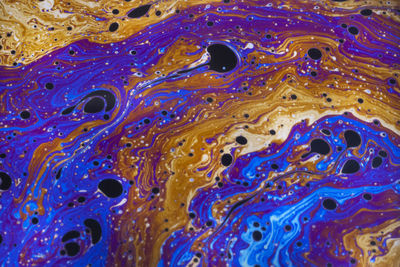 Macro photo of colourful pastel swirly patterns of a soap bubble