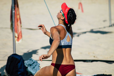 Full length of man holding umbrella on beach