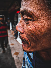 Close-up of man looking away outdoors