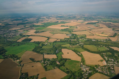 Aerial view of agricultural field against sky