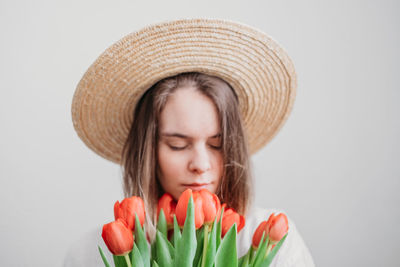 Portrait of woman wearing hat against white background