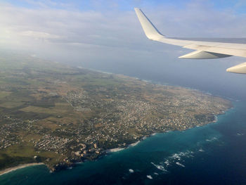Cropped image of airplane flying over cityscape