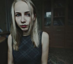 Close-up portrait of young woman at home