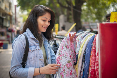 Smiling young woman standing in store