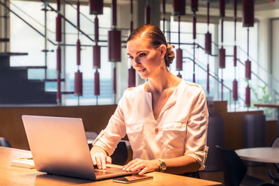 Portrait of young woman using smart phone