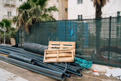 Chairs by swimming pool against buildings in city