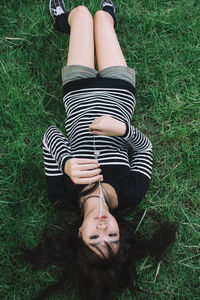 Low section of woman lying on grass