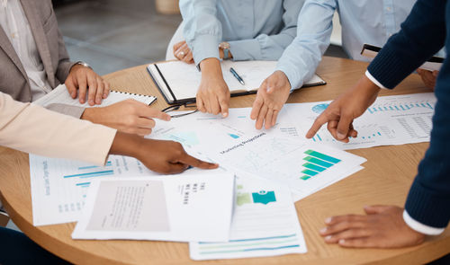 Midsection of business colleagues working at office