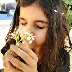 Close-up of beautiful woman holding flowers