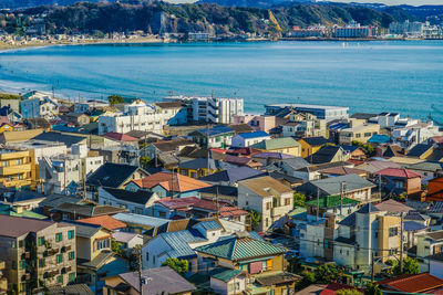 High angle view of townscape by sea