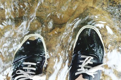 Low section of shoes on water