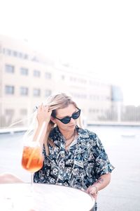 Portrait of a young woman drinking water