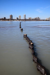 Scenic view of sea and buildings against sky