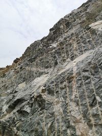 Low angle view of rocky mountains against sky