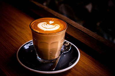 A cup of coffee latte top view with leaf shape foam