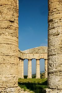 Old ruins against blue sky during sunny day