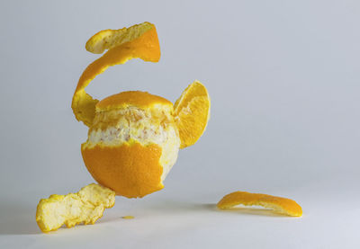 Close-up of orange fruit against white background