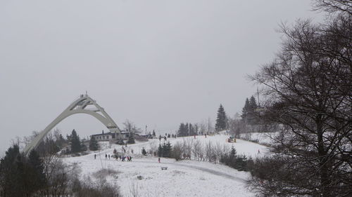 Scenic view of snow covered land against clear sky