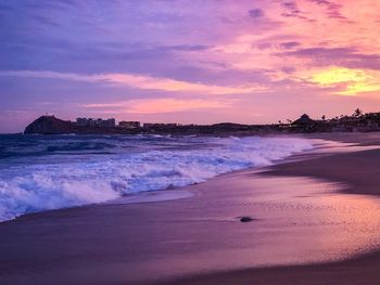 Scenic view of beach against sky during sunset