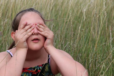 Portrait of a girl covering face