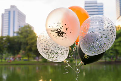 Close-up of balloons with reflection in water