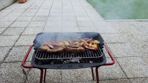 High angle view of meat on barbecue grill