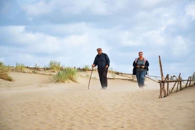 People on beach against sky