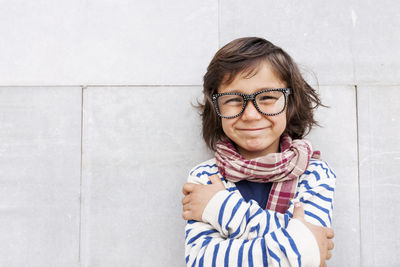 Portrait of grinning little boy wearing scarf and oversized glasses