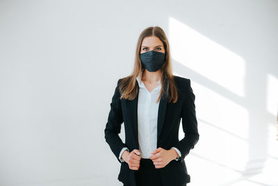 Photo of successful business woman wearing a breathing mask