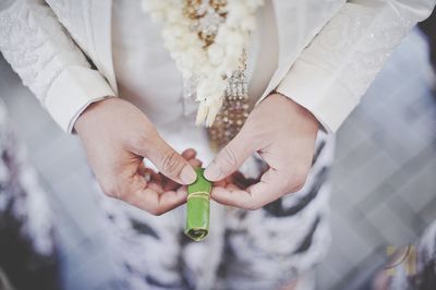 Midsection of bride holding hands