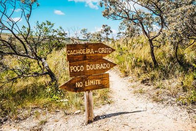 Information sign on landscape against sky