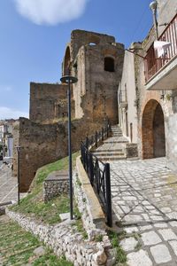 A narrow street between the old houses of grottole, a village in the basilicata region, italy.