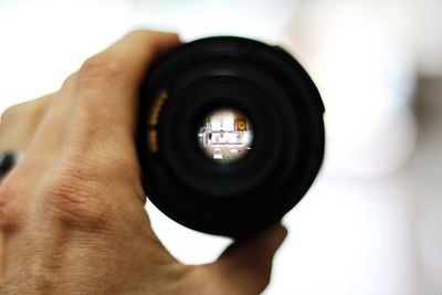 Cropped image of person holding a lens
